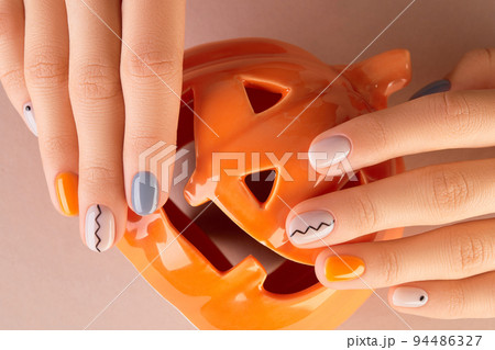 Manicured womans hands close up on beige background. Minimal autumn nail design 94486327