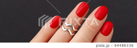 Close up womans hand with red matt nails on black background. Manicure, pedicure design trends Close up womans hand with red matt nails on black background. Manicure, pedicure design trends 94486336