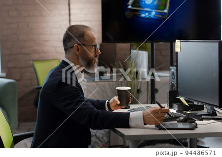 Caucasian artist draws on tablet 3D model of dog robot for computer game Caucasian artist draws on tablet 3D model of dog robot for computer game 94486571