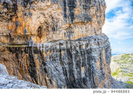 Tourist path in vertical wall of high mountain 94486883