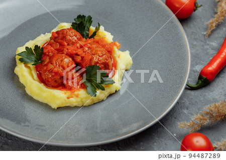 Meatballs in tomato sauce with mashed potato on the white plate, top view, view from above 94487289