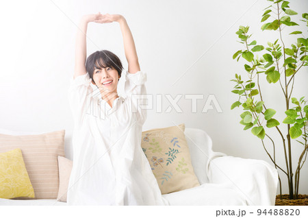 部屋でゆったりストレッチする女性 部屋でゆったりストレッチする女性 94488820