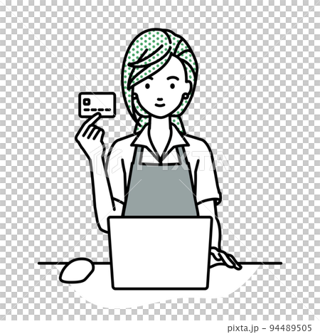 A female clerk sitting at a desk and using a PC while holding a credit card 94489505