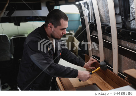 Man Building Camper Van Man Building Camper Van 94489586