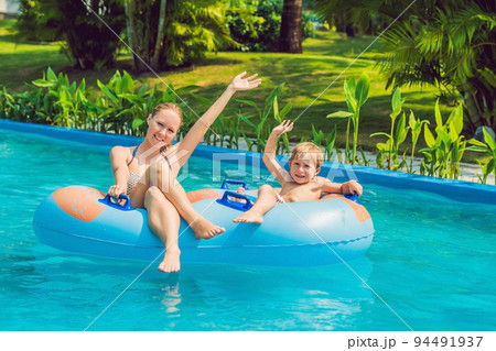Mom and son have fun at the water park 94491937