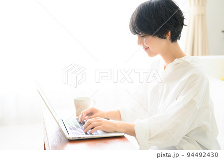コピースペースが使いやすい綺麗な逆光の中仕事をする女性 94492430
