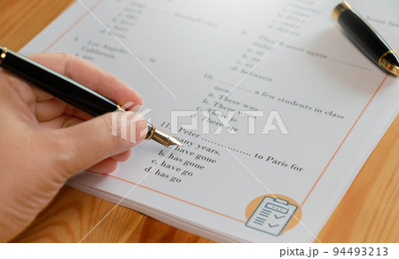 English test with pen on wooden table in class 94493213