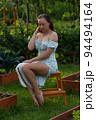 Sensitive woman sitting in garden 94494164
