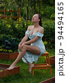 Sensitive woman sitting in garden 94494165