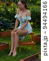 Sensitive woman sitting in garden 94494166