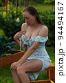 Sensitive woman sitting in garden 94494167