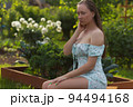 Sensitive woman sitting in garden 94494168