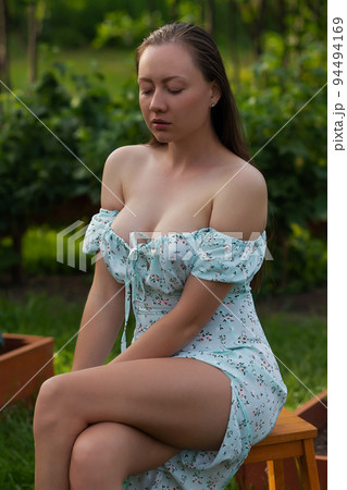 Sensitive woman sitting in garden Sensitive woman sitting in garden 94494169