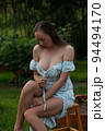 Sensitive woman sitting in garden 94494170