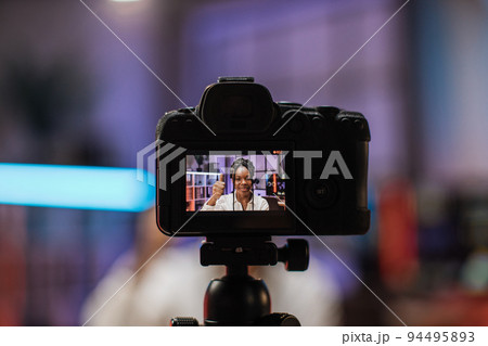 Focus on camera screen with attractive confident experienced smart female Focus on camera screen with attractive confident experienced smart female 94495893