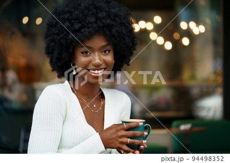 Young woman taking break and drinking coffee in cafe Young woman taking break and drinking coffee in cafe 94498352