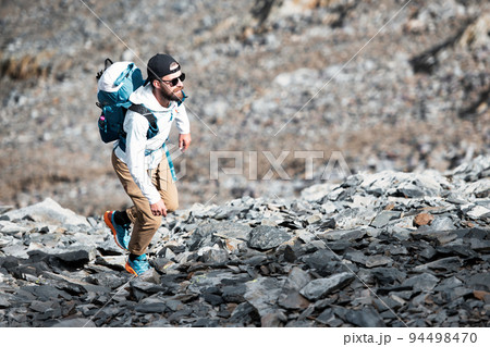 Man during an alpine trek Man during an alpine trek 94498470