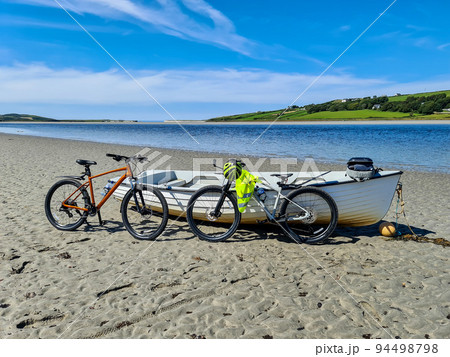 Concept of enjoying the outdoors by bicycle and boat at Gweebarra Bay , County Donegal - Ireland 94498798