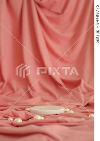 White marble podium on the pink background with pearls. Podium for product, cosmetic presentation. Creative mock up. Pedestal or platform for beauty products. 94499775
