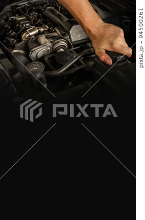 Auto mechanic working on car engine in mechanics garage. Repair service. Close-up shot. Free space for text, copy space Auto mechanic working on car engine in mechanics garage. Repair service. Close-up shot. Free space for text, copy space 94500261