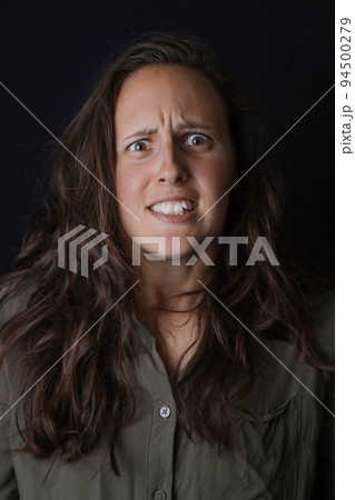 Portrait of impressed girl hear incredible news. Shocked female model on the black background. Expression emotions. Wow, omg, close up. 94500279