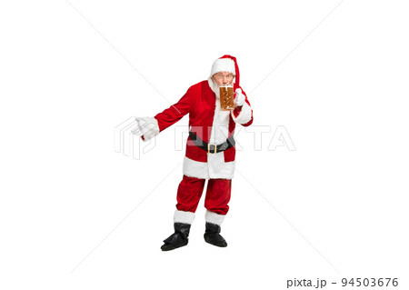 Portrait of senior man in image of Santa Claus sipping lager foamy beer isolated over white background. Portrait of senior man in image of Santa Claus sipping lager foamy beer isolated over white background. 94503676
