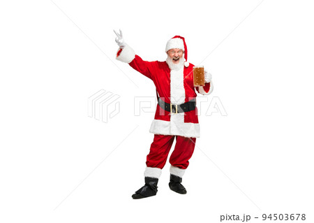 Portrait of senior man in image of Santa Claus posing with glass of lager foamy beer isolated over white background 94503678