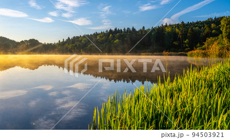 Idyllic sunny and hazy morning at the water 94503921