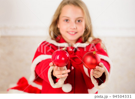 Getting child involved decorating. How to decorate christmas tree with kid. Girl smiling face hold balls ornaments white interior background. Let kid decorate christmas tree. Favorite part decorating 94504331