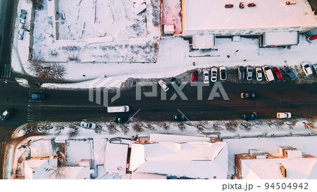 Top down aerial overhead perspective of street. Hyperlapse of car traffic on road passing through town at winter sunny evening, 94504942