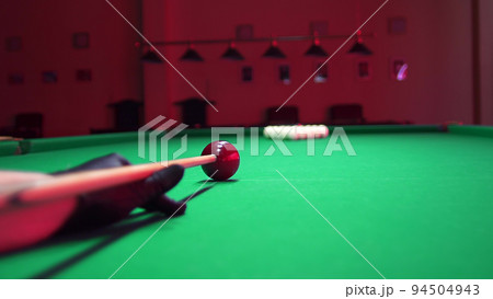 Man Playing Russian Billiards. First Blow Hit Breaking the Ball Pyramid. 4K colorcorrected footage Man Playing Russian Billiards. First Blow Hit Breaking the Ball Pyramid. 4K colorcorrected footage 94504943
