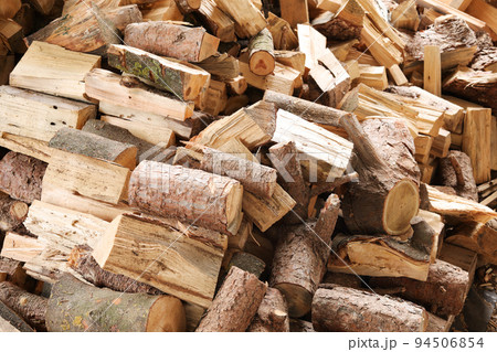 Closeup of chopped firewood. Firewood stacked and prepared for winter. Pile of wood. Closeup of chopped firewood. Firewood stacked and prepared for winter. Pile of wood. 94506854