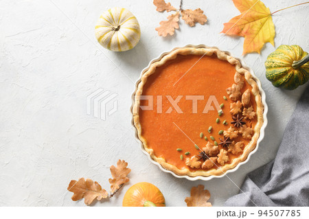 Homemade tasty pumpkin pie with autumn decorations and leaves for Thanksgiving Day on white. Homemade tasty pumpkin pie with autumn decorations and leaves for Thanksgiving Day on white. 94507785