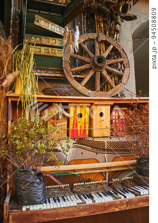 Cafe entrance decorated in Halloween style, with beautiful pumpkins, dried flowers, crows and antiques Cafe entrance decorated in Halloween style, with beautiful pumpkins, dried flowers, crows and antiques 94508809
