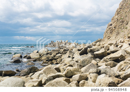sharp jagged basalt rocks on the sea coast 94508948