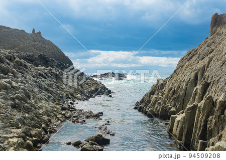 coastal cliffs formed by columnar basalt at low tide coastal cliffs formed by columnar basalt at low tide 94509208