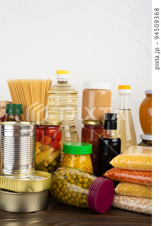 Emergency survival food set on dark wooden kitchen table 94509368