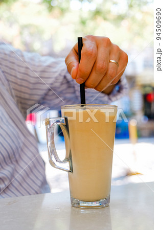 Ice latte coffee with a straw on the table. 94509690
