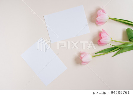 Beautiful composition spring flowers. Blank frame for text, pink tulips flowers on beige background. Valentine's Day, Easter, Birthday, Happy Women's Day. Flat lay, top view, copy space 94509761