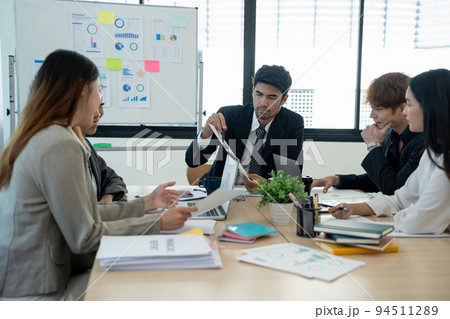 diverse business team people and female leader boss discuss financial result review paperwork share ideas brainstorm collaborate work in teamwork at group briefing table 94511289