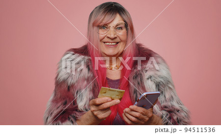 Senior woman using credit bank card smartphone while transferring money, purchases online shopping Senior woman using credit bank card smartphone while transferring money, purchases online shopping 94511536