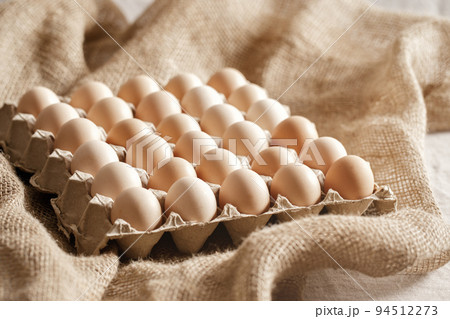 Fresh organic chicken eggs in carton pack or egg paper container on a sacking. Zero waste packaging concept 94512273