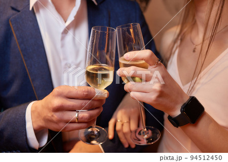 Celebrating with glasses of alcohol in hands. Happy female friends having good time. 94512450