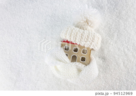 Figure of house and warm clothes on the snow background. Heating season concept. European energy crisis concept.  94512969