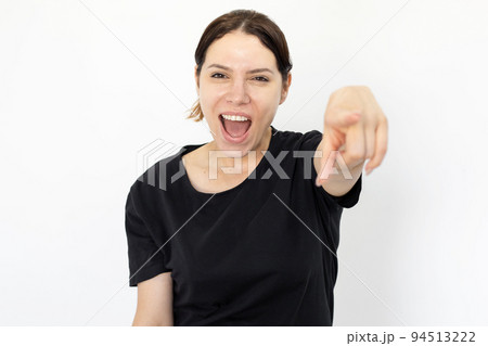 Happy woman pointing finger at camera and smiling 94513222