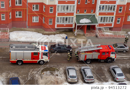 Fire engine in the courtyard of a multi-storey residential building in winter. Fire engine in the courtyard of a multi-storey residential building in winter. 94513272