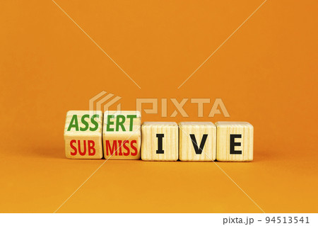 Submissive or assertive symbol. Concept words Submissive and assertive on wooden cubes. Beautiful orange background. Business, psychological submissive assertive concept. Copy space. Submissive or assertive symbol. Concept words Submissive and assertive on wooden cubes. Beautiful orange background. Business, psychological submissive assertive concept. Copy space. 94513541