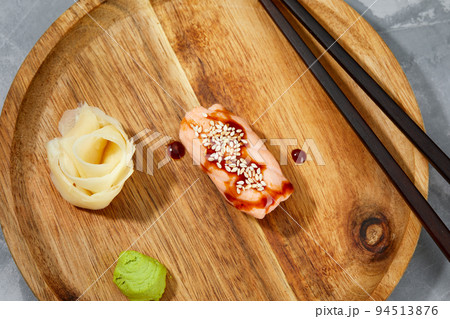 Sushi with smoked eel and sesame seeds on a wooden board. Japanese dish Unagi sushi. 94513876