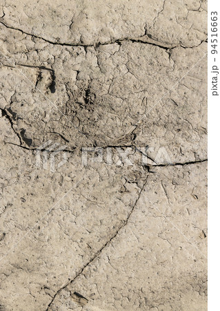 Cracked dry soil in an agricultural field, close up Cracked dry soil in an agricultural field, close up 94516663