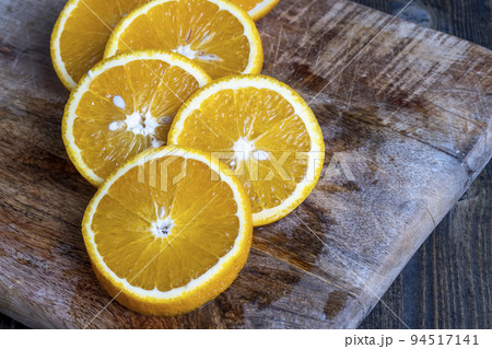 ripe orange cut into slices during cooking 94517141